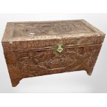 A Chinese heavily carved camphor wood blanket chest, width 101cm.