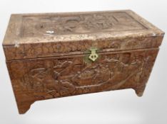 A Chinese heavily carved camphor wood blanket chest, width 101cm.