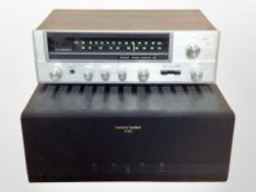 A Sansui stereo receiver 221 and a Harman/Kardon PA4000 receiver.