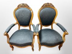 A pair of 19th century continental carved walnut salon armchairs in black floral upholstery