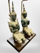 A pair of Thai patinated and gilt metal figural table lamps with shades,