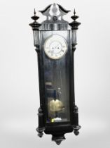 An ebonised Vienna style wall clock with enameled dial, height 121 cm.
