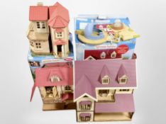 A group of Sylvanian Families model houses, some boxed.