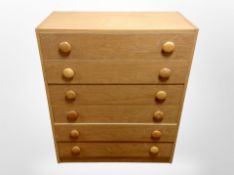 A late 20th century Danish oak veneerer six drawer chest ,