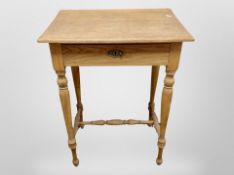 An early 20th century blond oak work table, fitted a drawer, containing threads,