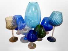 A group of oversized coloured glass goblets.