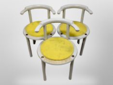 A set of three 20th century Danish circular shaped armchairs with yellow pad seats