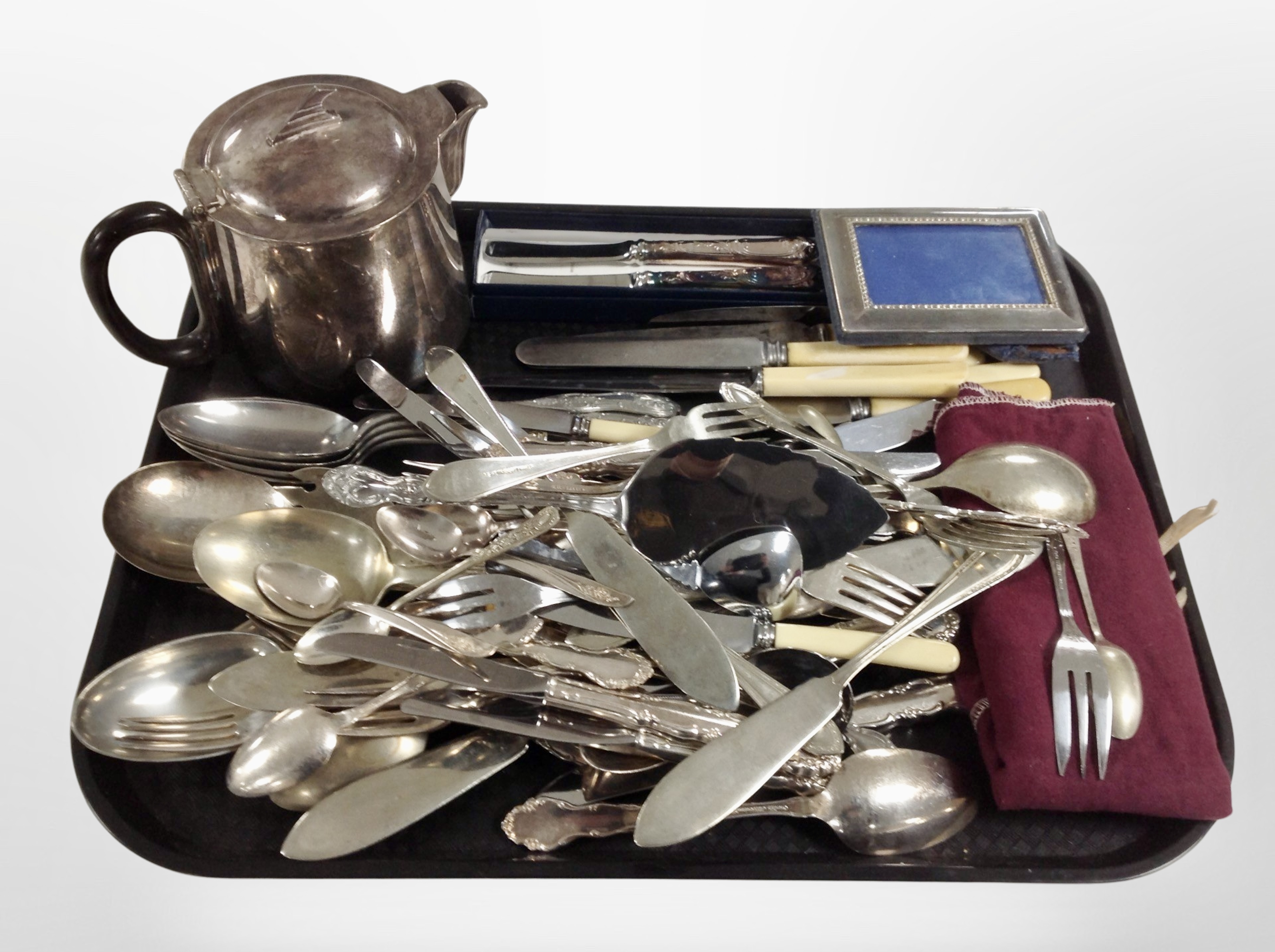 A group of silver-plated and stainless steel cutlery, photo frame, teapot, etc.