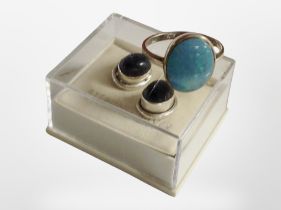 A pair of stirling silver earrings and a silver and opal ring.