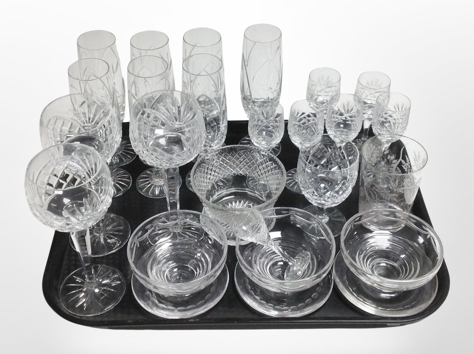 A set of 7 crystal champagne flutes, further drinking glasses, etched grapefruit bowls.