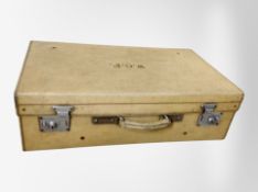 An early 20th century pigskin suitcase, width 67cm.