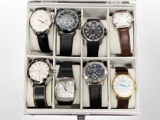 A watch display case containing eight Gentleman's wrist watches by Daniel Hechter, Seiko,