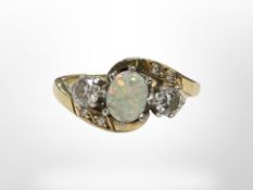 An 18ct yellow gold opal and two stone diamond ring, size G/H. CONDITION REPORT: 3.