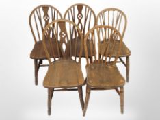 Eight assorted oak and elm spindle backed dining chairs