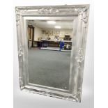 A silvered-framed bevelled overmantel mirror, 122cm x 92cm, and one other mirror.