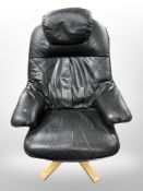 A late 20th century black stitched leather armchair on beech support