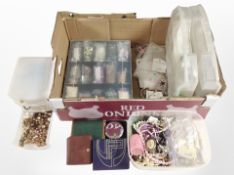 A box of assorted costume jewellery contained in plastic jewellery boxes, leather purses, etc.