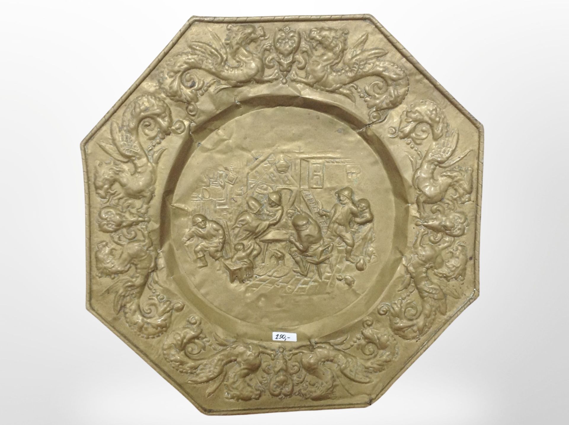 A contintental embossed octagonal brass charger, diameter 59cm.