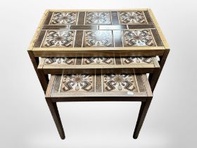 A 1970's Danish teak nest of three tile inset tables,