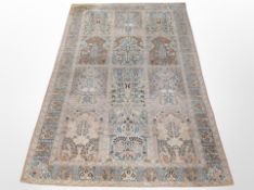 A machine-made rug of Persian Ghom design, 243cm x 153cm.