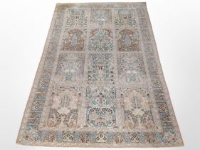 A machine-made rug of Persian Ghom design, 243cm x 153cm.