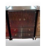 A Stag Minstrel double-door cabinet with drawers beneath, width 82cm.