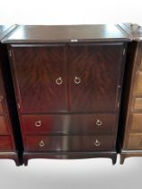 A Stag Minstrel double-door cabinet with drawers beneath, width 82cm.