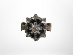 A 9ct yellow gold diamond and sapphire cluster ring, size L/M. CONDITION REPORT: 3.