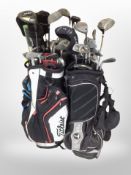 Several golf bags containing assorted irons and drivers including Dunlop, Edge,