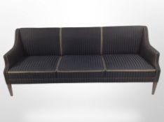 A mid 20th century Danish three piece lounge suite : three seater settee and pair of armchairs