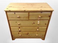 A contemporary pine and MDF five drawer chest,