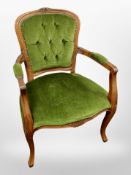 A continental carved beech salon armchair in green upholstery