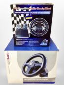 Two boxed gaming steering wheels for Playstation 2 and Playstation 3.