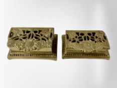 A pair of graduated brass stamp holders.