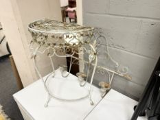 A wrought metal demi-lune table and a further plant pot holder