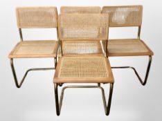 A set of four teak and metal-framed Cantilever chairs with cane seats and backrests.