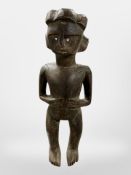 An African carved wooden fertility figure, height 26cm.