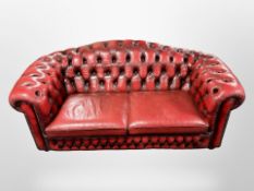 A Chesterfield red button leather three-seater settee,