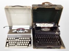 A vintage Olympia typewriter with one other.