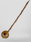 A large rustic smoking pipe, length 70cm.