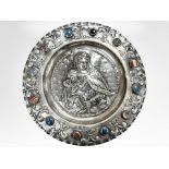 A Columbian silver charger, cast in relief with The Madonna and Child,