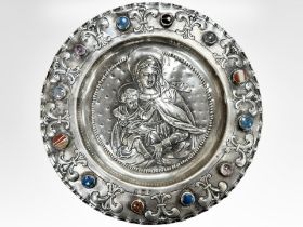 A Columbian silver charger, cast in relief with The Madonna and Child,