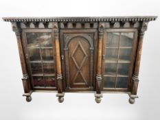 An early 19th century continental carved oak bookcase, with pillar supports,