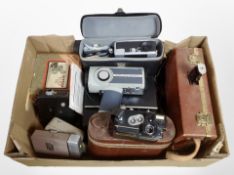 A collection of vintage cameras and handheld video cameras including Eymig, Kodak, etc.