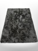 A contemporary black shaggy pile rug,