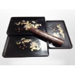 Three graduated oriental lacquered trays,