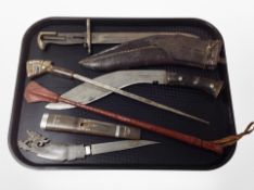 A kukri knife in sheath, together with two further Eastern horn-handled knives and a bayonet.