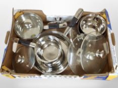 A box of contemporary kitchen cooking pots.