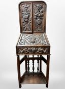 An 18th century Flemish carved oak double door fall-front cabinet on stand,