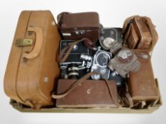 A collection of vintage cameras and handheld video cameras including Bolex, Elmo, etc.